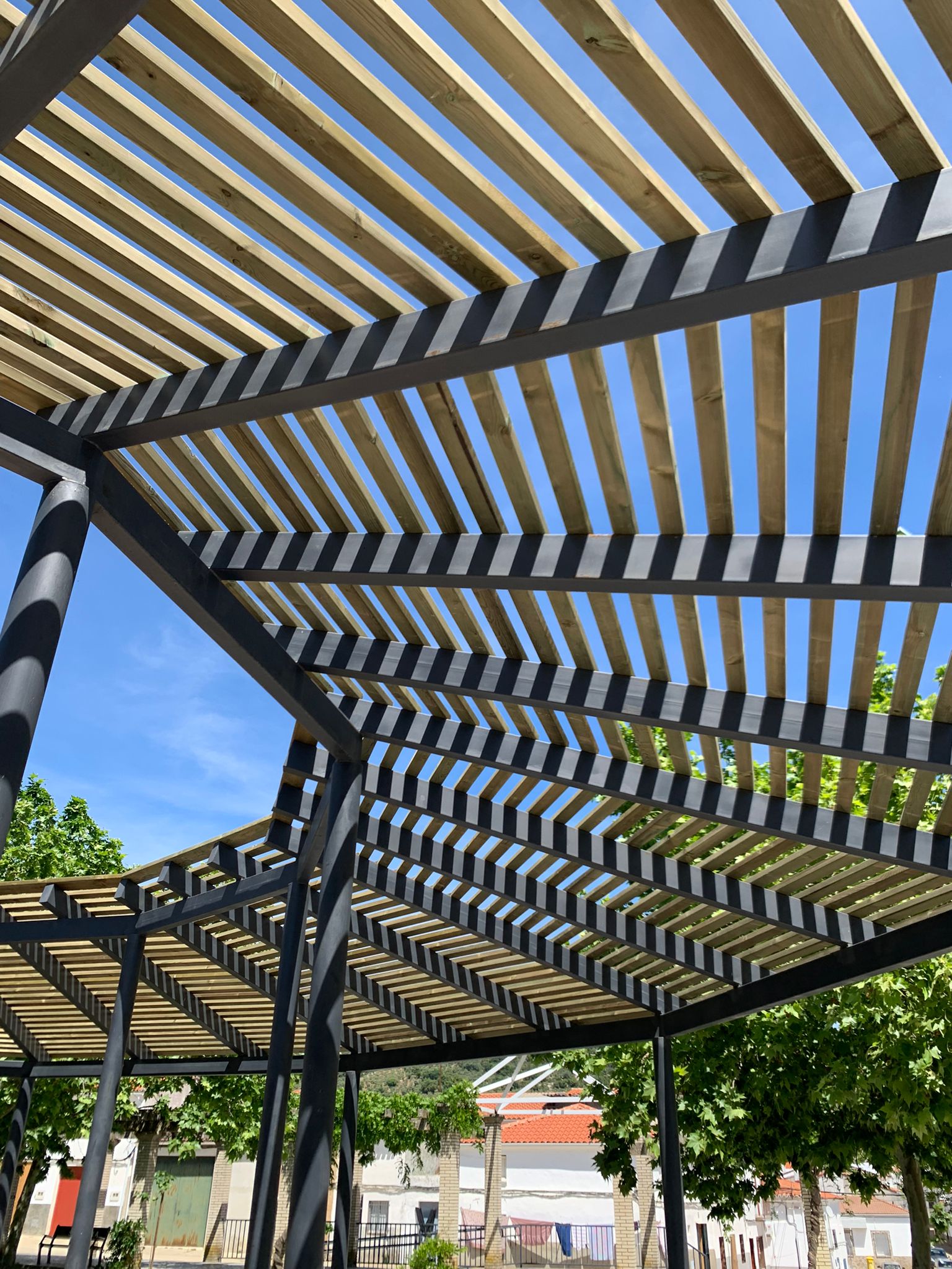 Estructura sostenible con postes metálicos y traviesas de madera